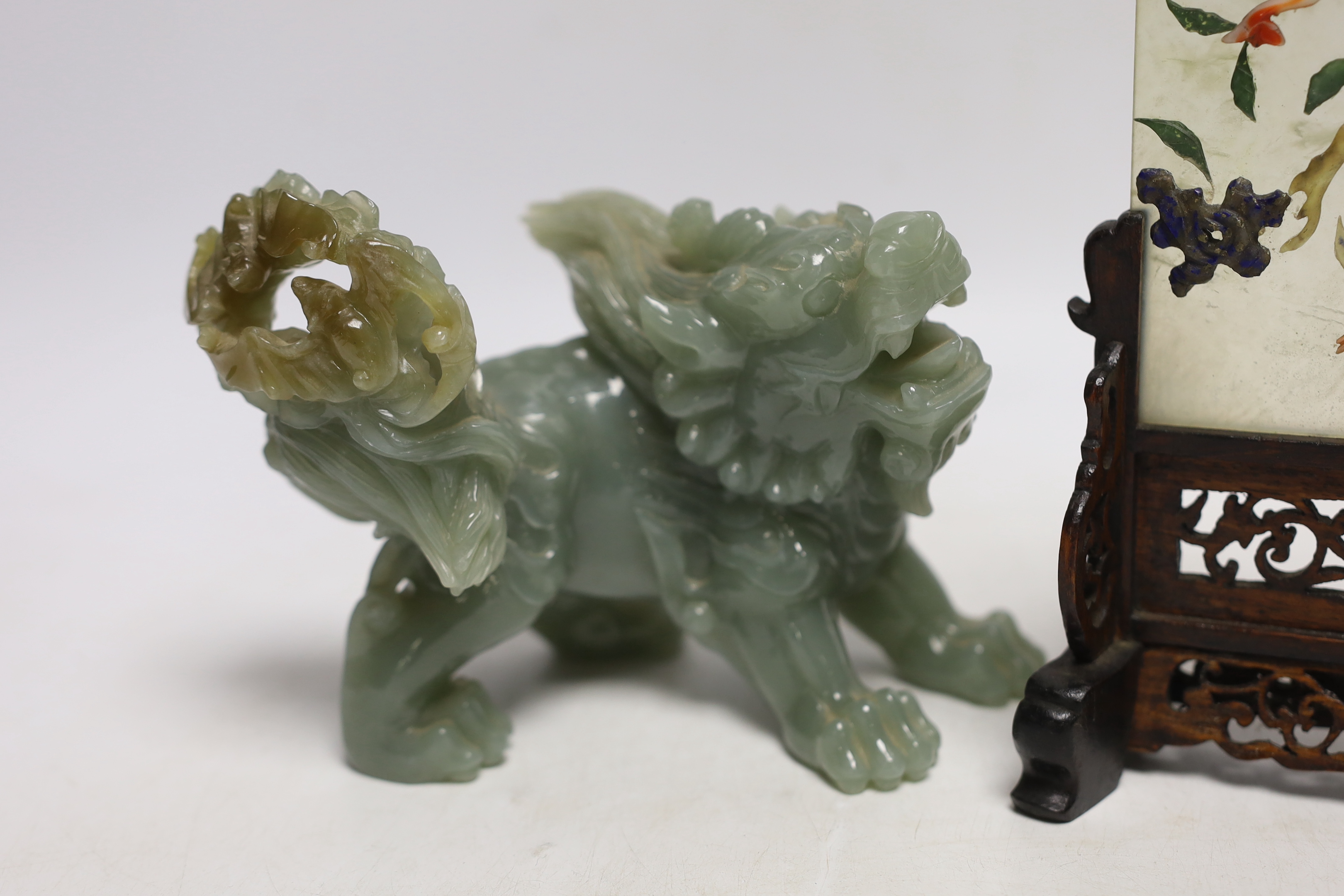 An early 20th century Chinese hardstone, lapis lazuli, coral and hardwood table screen together with a Chinese green jade lion dog, tallest 18cm